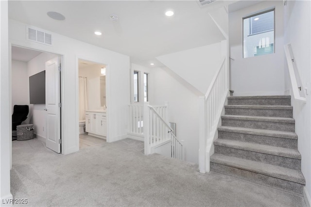 staircase featuring carpet flooring