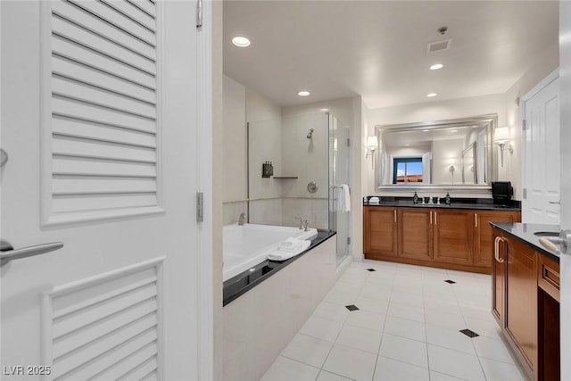 full bath with tile patterned flooring, visible vents, vanity, a bath, and a stall shower