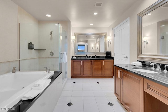 full bathroom featuring a garden tub, visible vents, a stall shower, vanity, and tile patterned floors