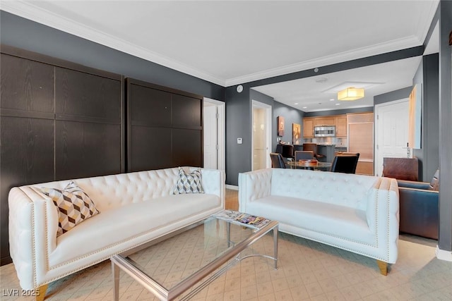 living room with ornamental molding and baseboards