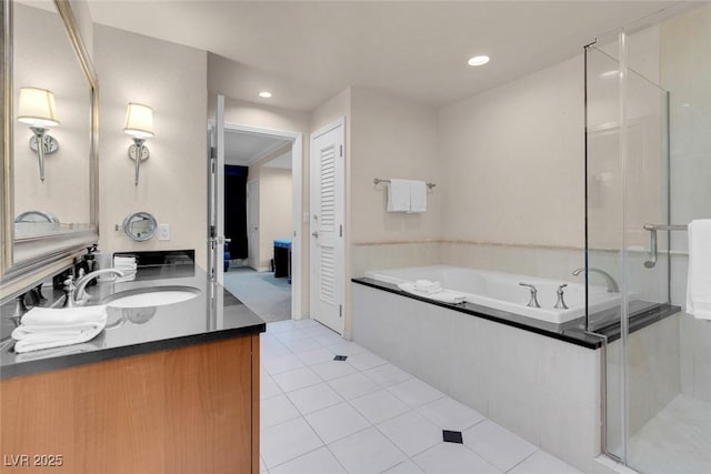 full bath featuring vanity, a closet, a bath, tile patterned floors, and a stall shower