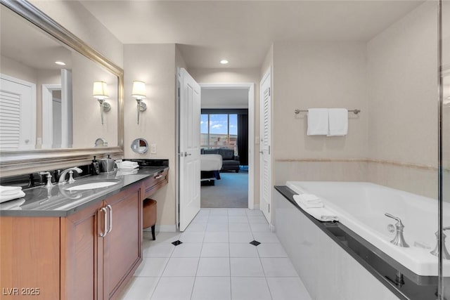 bathroom featuring tile patterned floors, ensuite bathroom, a garden tub, vanity, and recessed lighting