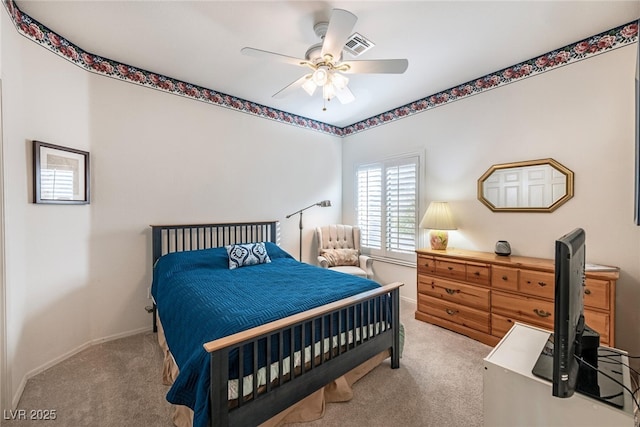 bedroom featuring ceiling fan and light carpet