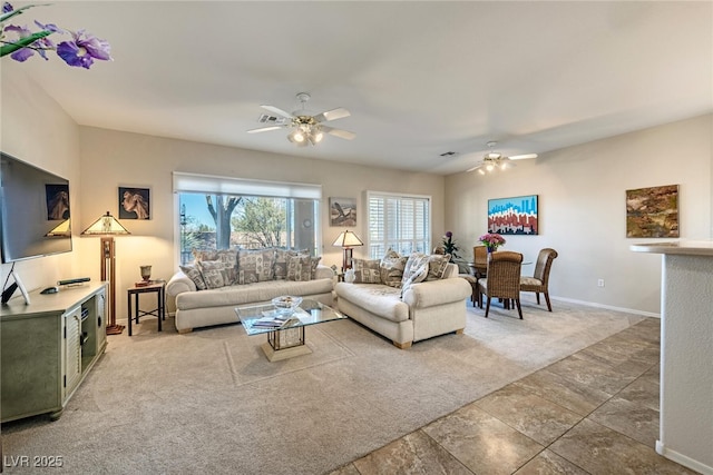 carpeted living room with ceiling fan