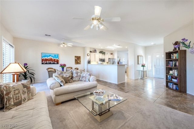 living room featuring light tile patterned flooring and ceiling fan