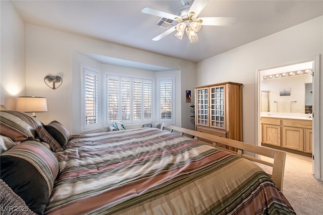 carpeted bedroom featuring ensuite bathroom and ceiling fan