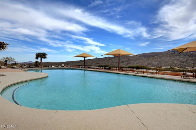 view of pool with a patio and a mountain view