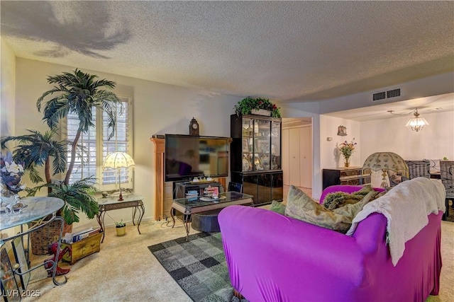 living room featuring light carpet and a textured ceiling