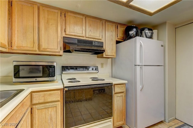 kitchen with light brown cabinetry, range with electric cooktop, and white refrigerator