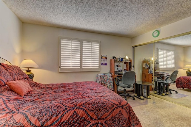 bedroom with a closet, a textured ceiling, and carpet