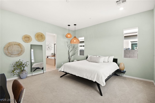 carpeted bedroom featuring ensuite bathroom