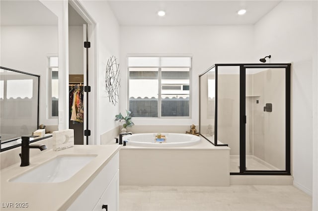 bathroom with vanity and separate shower and tub