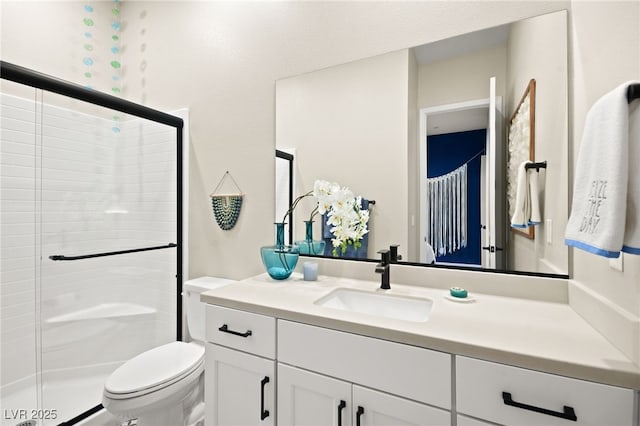 bathroom with vanity, walk in shower, and toilet