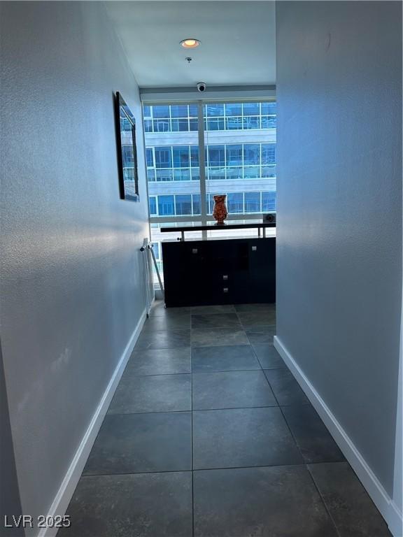 corridor featuring dark tile patterned flooring