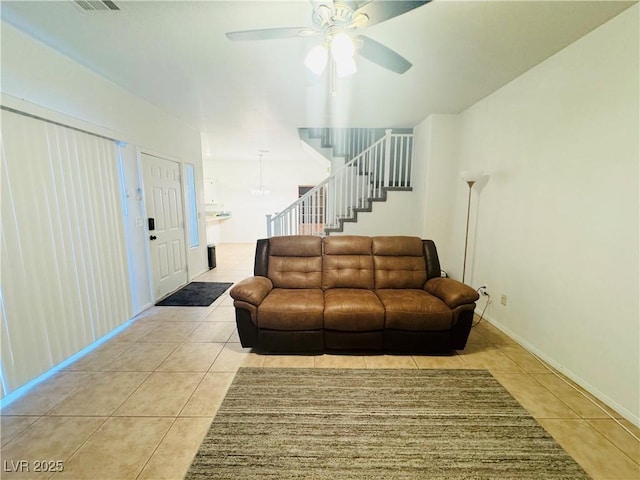 tiled living room featuring ceiling fan