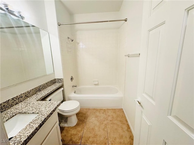 full bathroom featuring vanity, tile patterned flooring, toilet, and tiled shower / bath combo