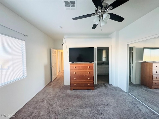 unfurnished bedroom with ceiling fan, connected bathroom, and carpet flooring