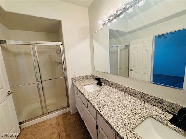 bathroom with vanity, tile patterned floors, and a shower with door