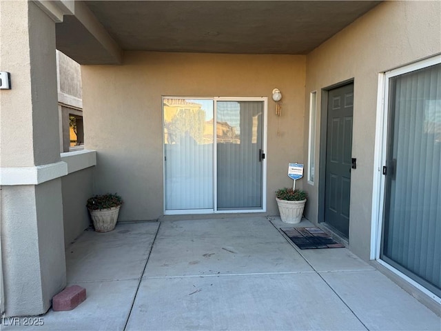 property entrance with a patio area