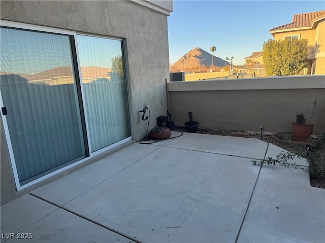 view of patio featuring a balcony and a mountain view