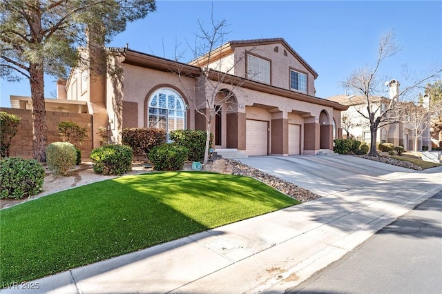 mediterranean / spanish house with a garage and a front yard