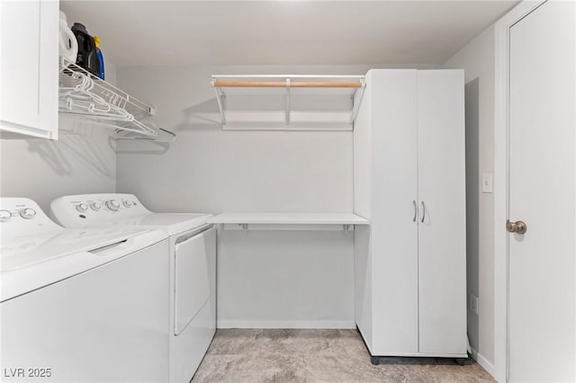 clothes washing area featuring washer and clothes dryer and cabinets