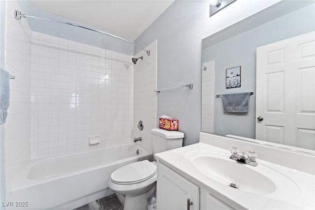 full bathroom featuring vanity, tiled shower / bath combo, and toilet