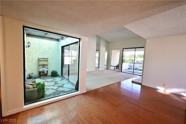 entryway with hardwood / wood-style flooring and a textured ceiling