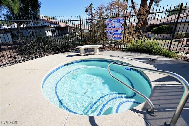 view of swimming pool featuring a hot tub