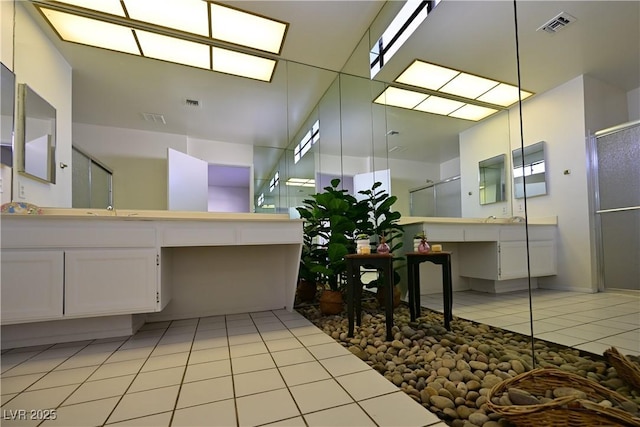 bathroom featuring tile patterned flooring, vanity, and an enclosed shower