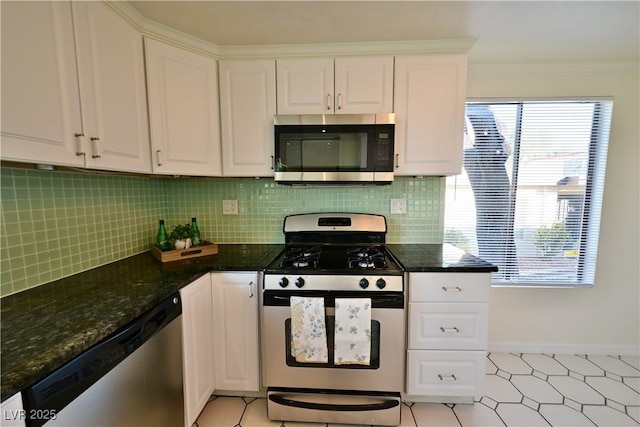 kitchen with tasteful backsplash, ornamental molding, stainless steel appliances, and white cabinets