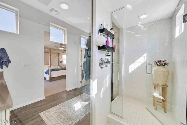 bathroom featuring wood-type flooring and a shower with shower door