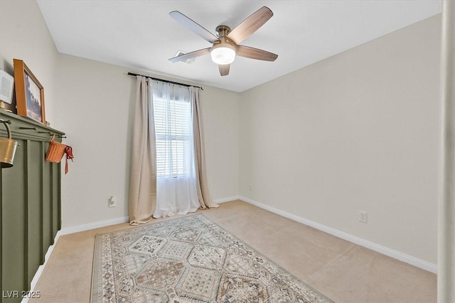 empty room with light carpet and ceiling fan