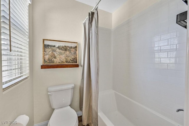 bathroom with shower / bathtub combination with curtain and toilet