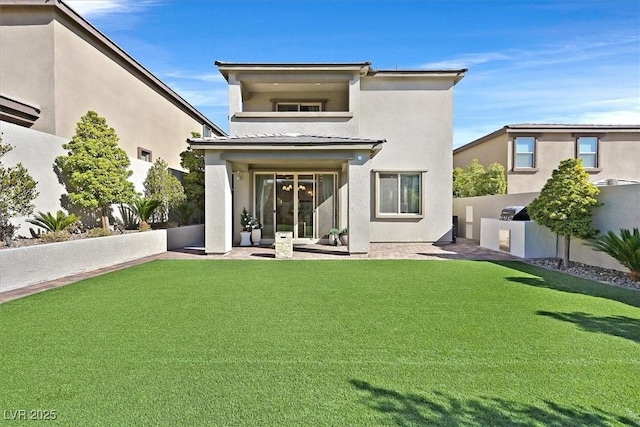 rear view of house featuring a yard, a patio, and exterior kitchen