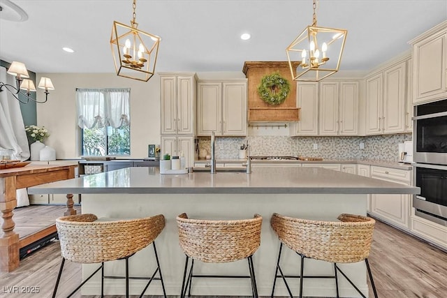 kitchen featuring a breakfast bar area, a notable chandelier, and decorative light fixtures