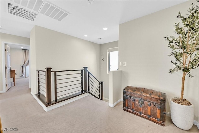 hallway featuring light colored carpet