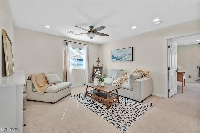 carpeted living room featuring ceiling fan