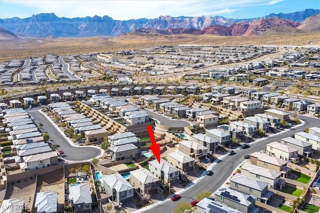 birds eye view of property with a mountain view