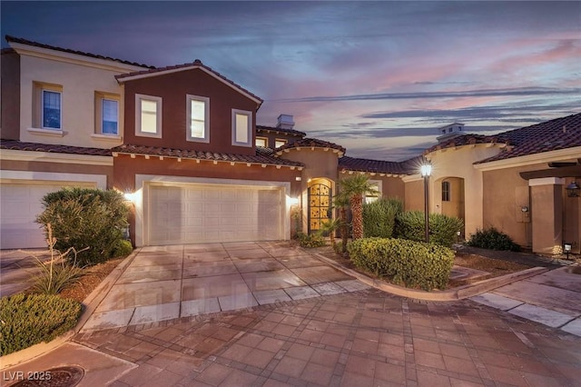 mediterranean / spanish-style house featuring a garage