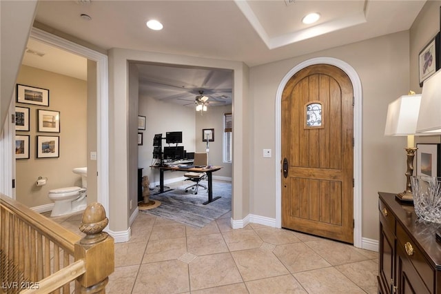 entryway featuring light tile patterned flooring and ceiling fan