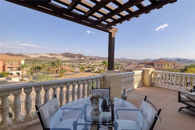 balcony featuring a mountain view and a pergola