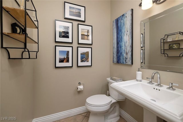 bathroom with sink, tile patterned floors, and toilet