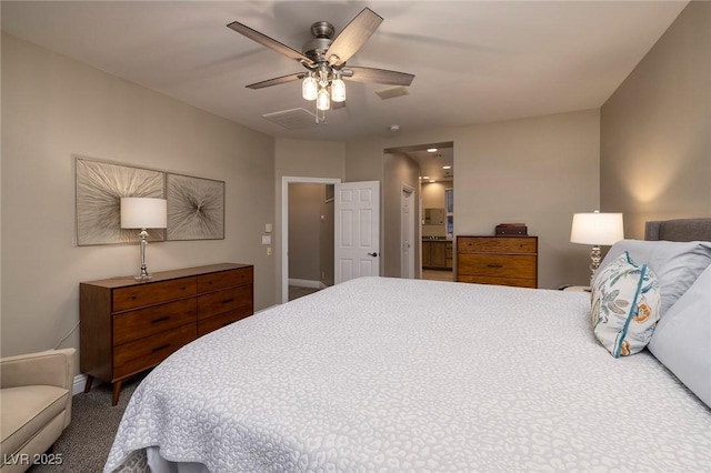 carpeted bedroom featuring ensuite bathroom and ceiling fan