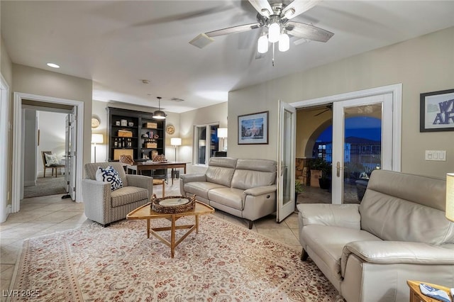 living room featuring ceiling fan and light tile patterned floors