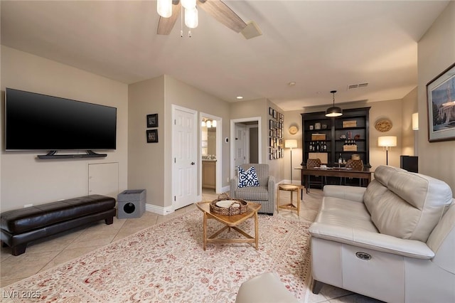 living room with ceiling fan and light tile patterned flooring