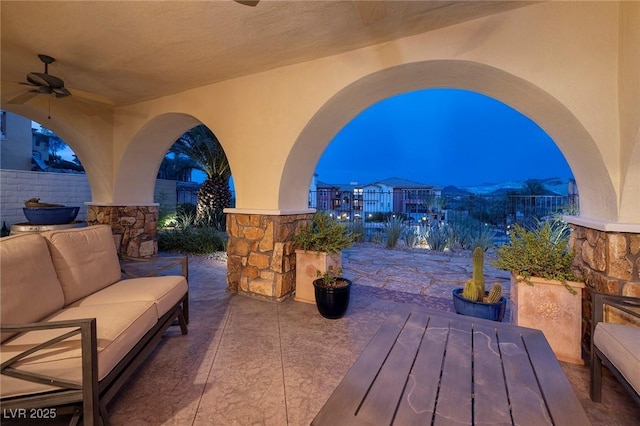 view of patio with ceiling fan and an outdoor living space