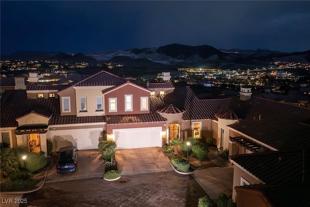 view of front of home with a mountain view and a garage