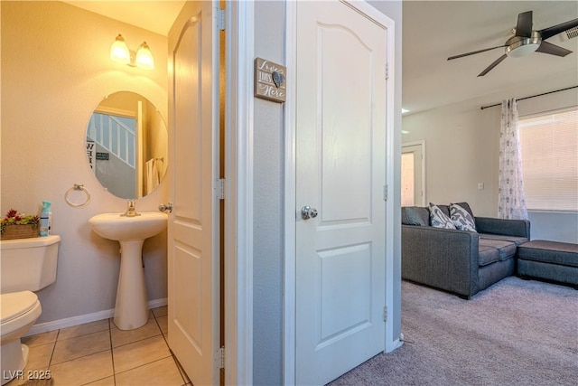 bathroom with ceiling fan, tile patterned floors, and toilet