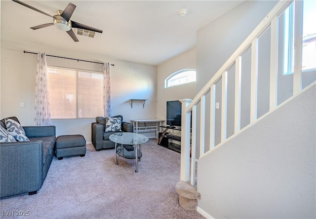 carpeted living room with ceiling fan